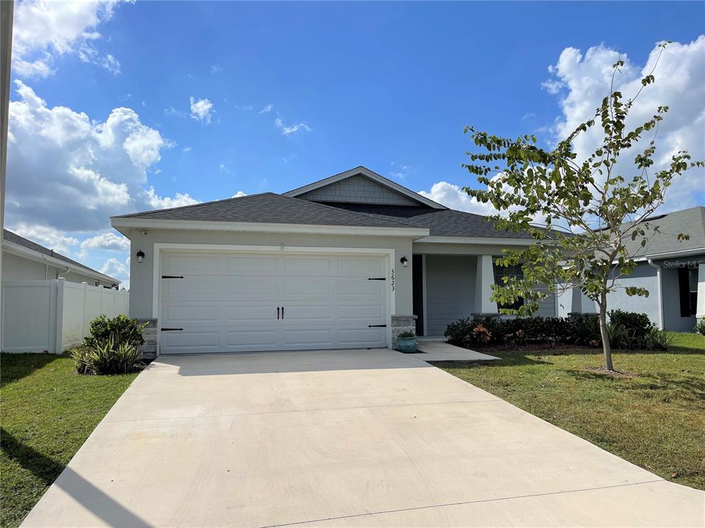 3623 Peregrine Way Lakeland, FL 33811 - Photo 34 of 35 a front view of a house with a yard and garage