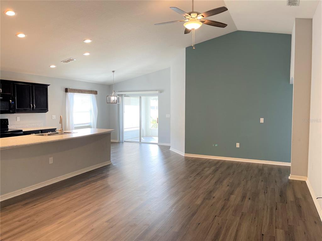 3623 Peregrine Way Lakeland, FL 33811 - Photo 4 of 35 a view of empty room with wooden floor and fan