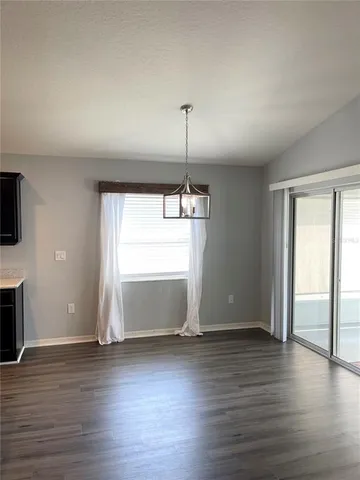 a view of a room with wooden floor and fireplace