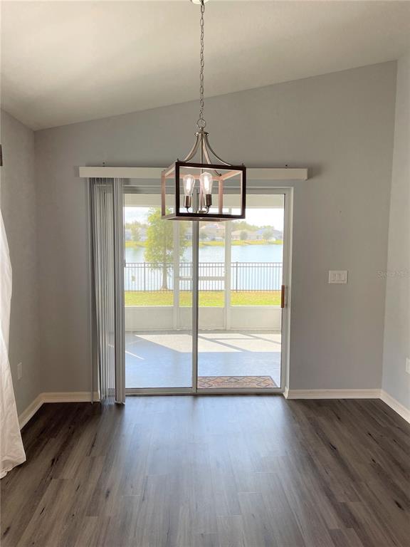 3623 Peregrine Way Lakeland, FL 33811 - Photo 10 of 35 a view of an empty room with wooden floor and a window
