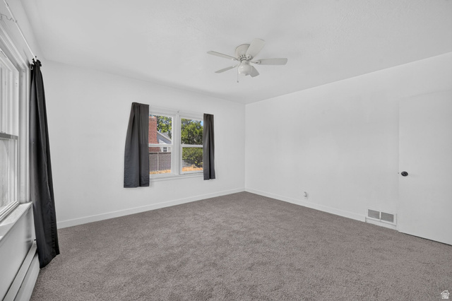 220 East Greenwood Avenue Midvale, UT 84047 - Photo 16 of 46 Neutral white wall finishes with grey carpet flooring