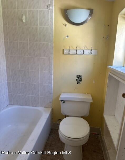 725 Highway 32 Tillson, NY 12486 - Photo 12 of 26 a bathroom with a toilet and a bathtub