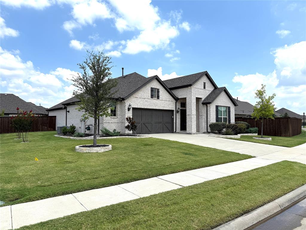 1615 Seashore Avenue Celina, TX 75009 - Photo 1 of 1 a front view of a house with a yard and garage