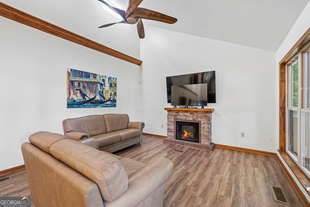 730 Marigold Road Sparta, GA 31087 - Photo 12 of 35 a living room with furniture and a fireplace