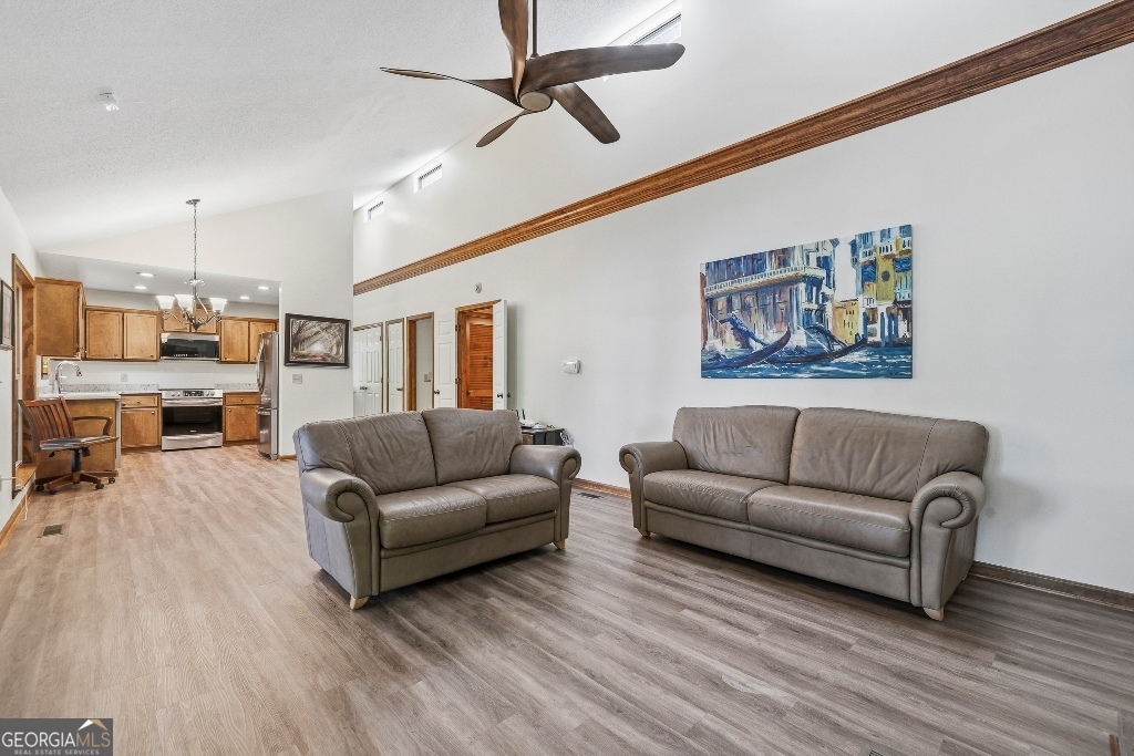 730 Marigold Road Sparta, GA 31087 - Photo 14 of 35 a living room with furniture and a view of kitchen