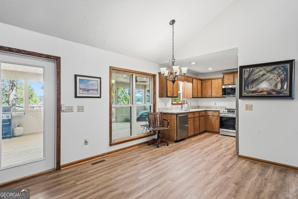 730 Marigold Road Sparta, GA 31087 - Photo 16 of 35 a large kitchen with stainless steel appliances granite countertop a refrigerator a oven a sink with wooden floors and couches
