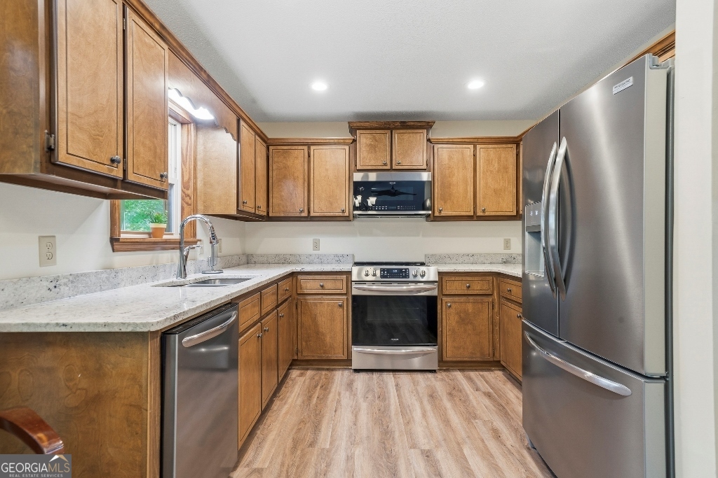 730 Marigold Road Sparta, GA 31087 - Photo 17 of 35 a kitchen with stainless steel appliances granite countertop a refrigerator sink and stove