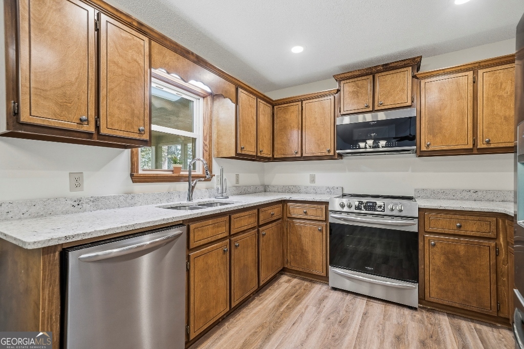 730 Marigold Road Sparta, GA 31087 - Photo 18 of 35 a kitchen with stainless steel appliances granite countertop a stove a sink and a microwave
