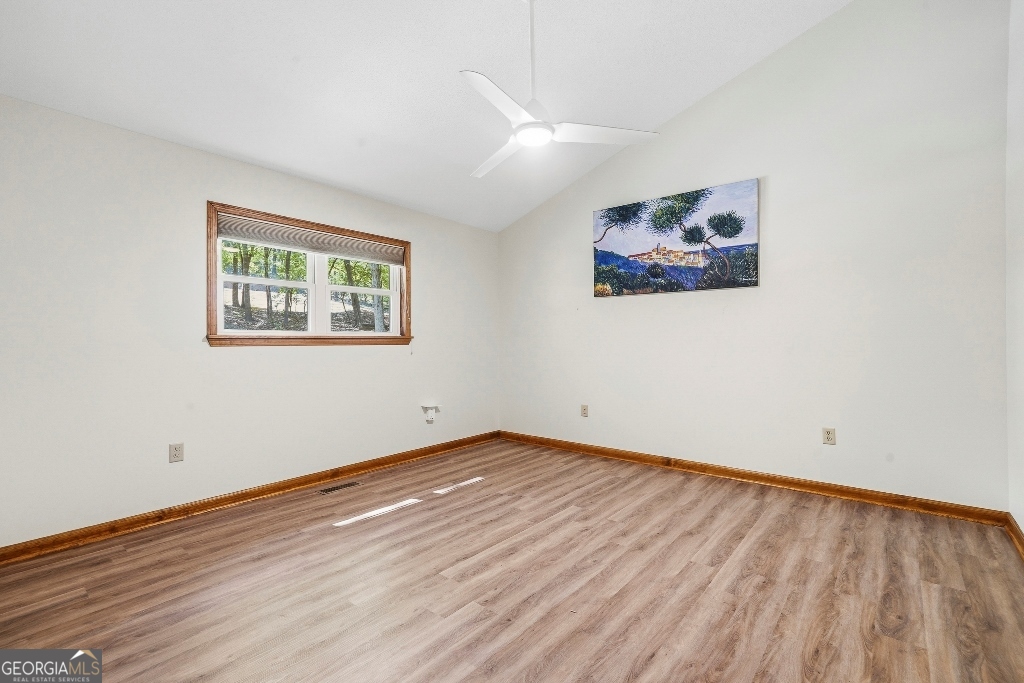 730 Marigold Road Sparta, GA 31087 - Photo 27 of 35 an empty room with wooden floor and windows