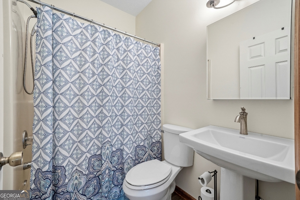 730 Marigold Road Sparta, GA 31087 - Photo 29 of 35 a bathroom with a sink and a toilet