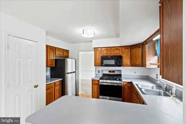 a kitchen with a stove a sink and a refrigerator
