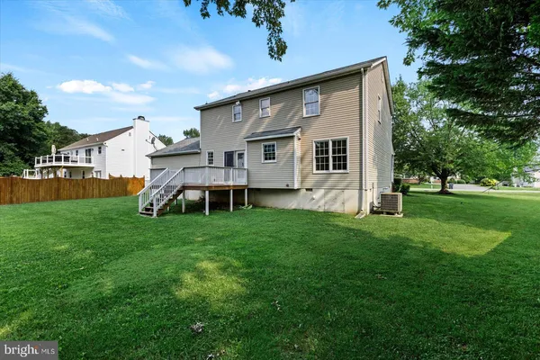 a front view of a house with a yard and trees