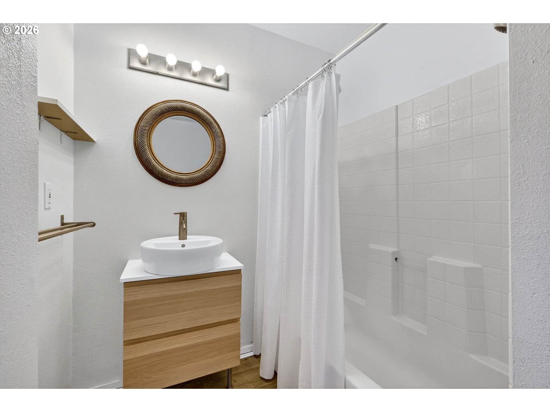 134 South 3rd Street St. Helens, OR 97051 - Photo 13 of 21 a bathroom with a sink a mirror and a shower