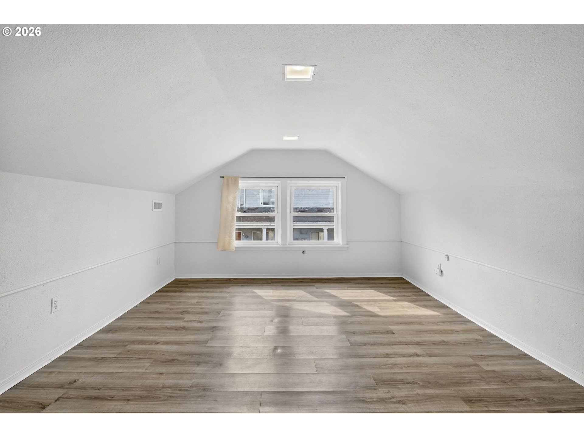 134 South 3rd Street St. Helens, OR 97051 - Photo 17 of 21 a view of an empty room with wooden floor and a window