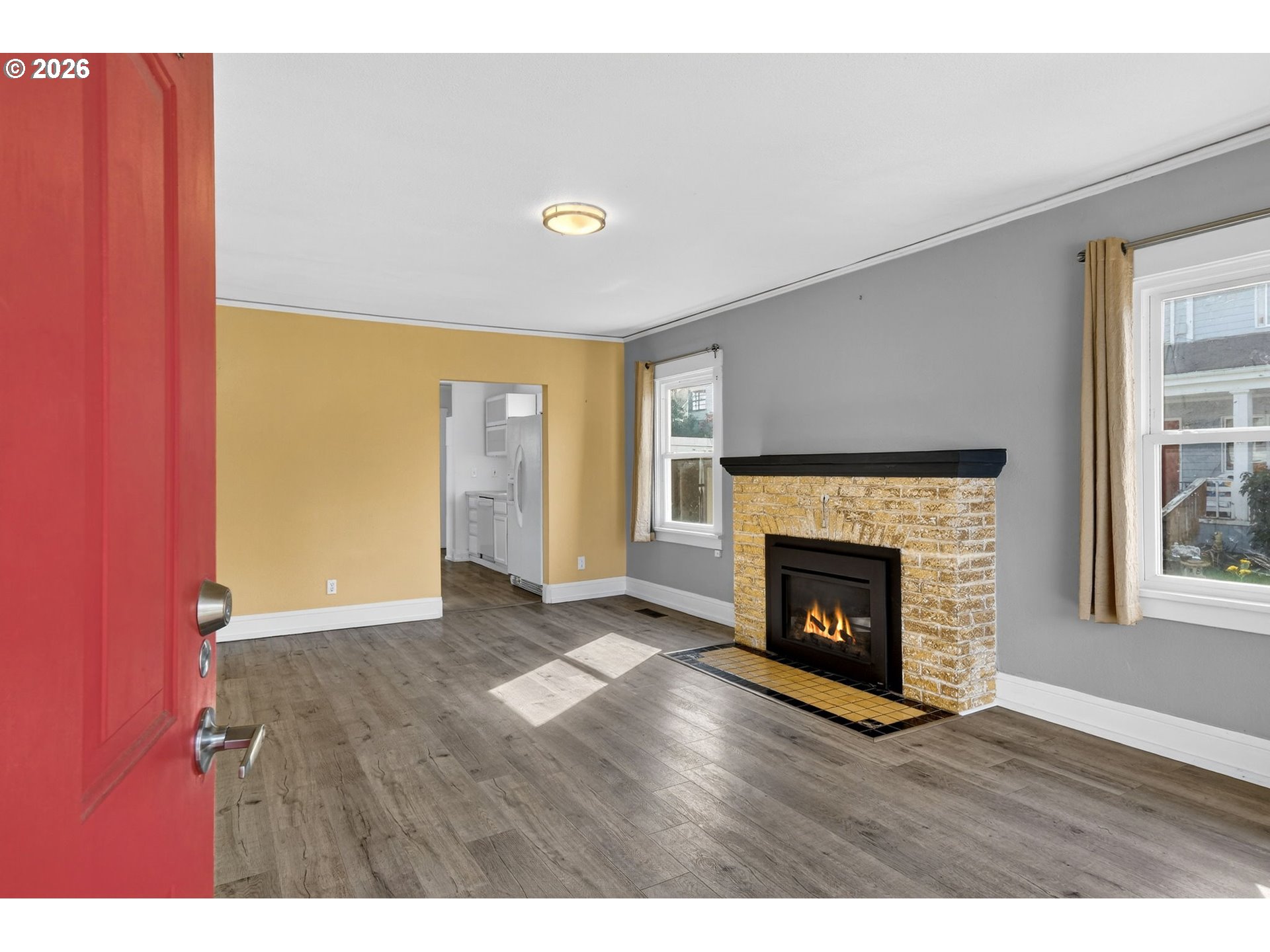 134 South 3rd Street St. Helens, OR 97051 - Photo 3 of 21 a view of an empty room with wooden floor fireplace and a window