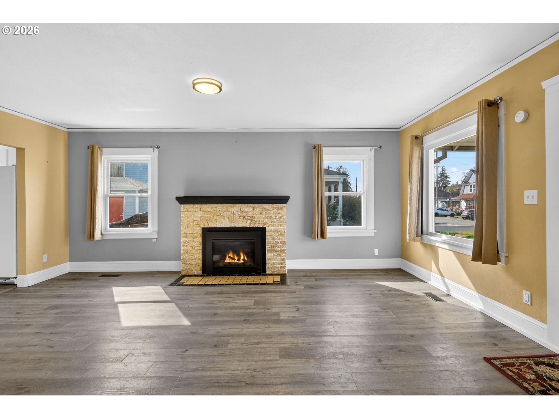 134 South 3rd Street St. Helens, OR 97051 - Photo 4 of 21 a view of an empty room with window and fire place