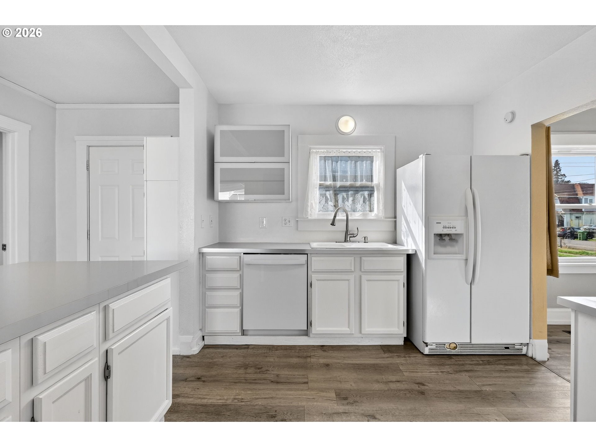 134 South 3rd Street St. Helens, OR 97051 - Photo 7 of 21 a kitchen with white cabinets and sink