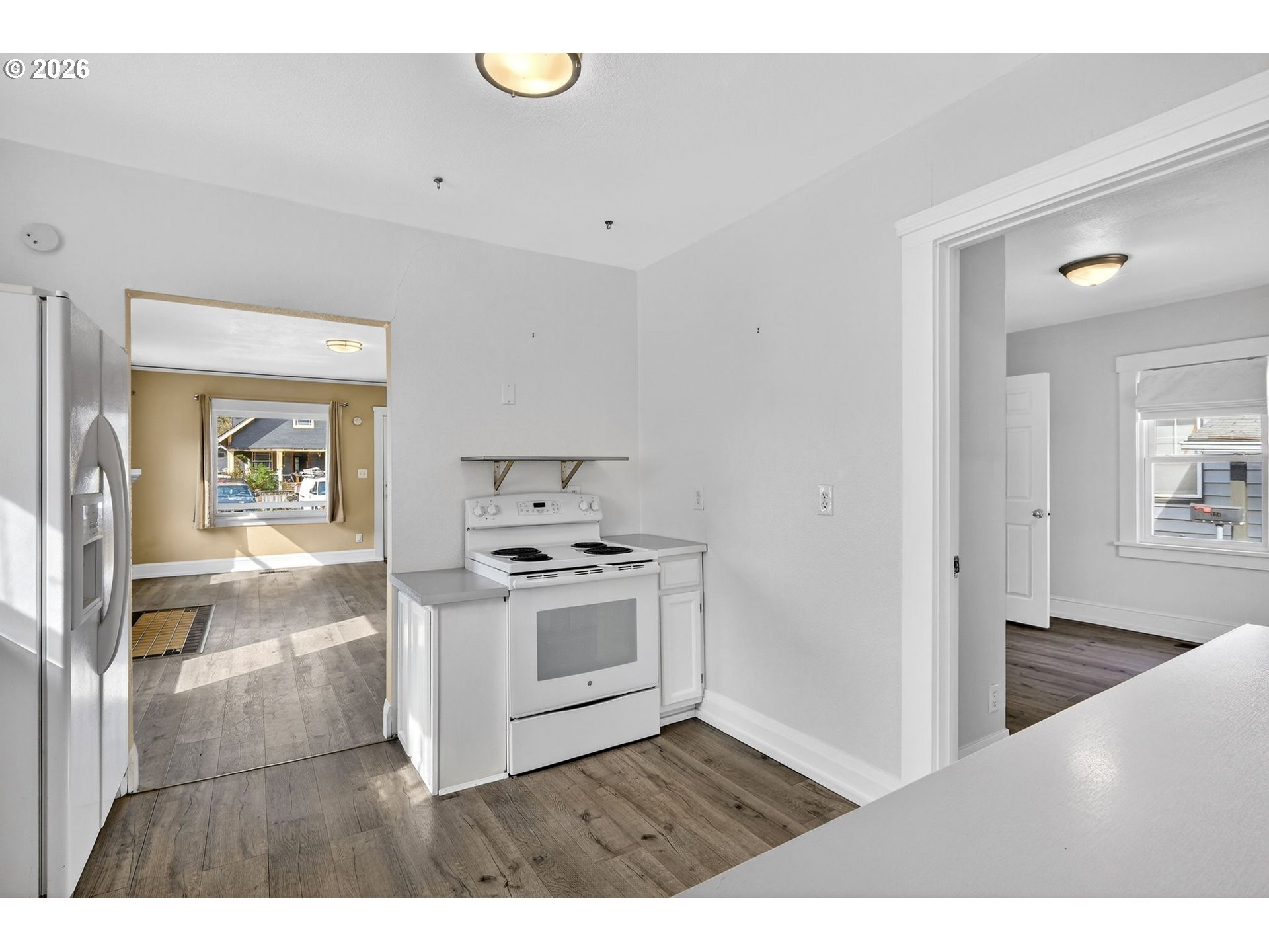 134 South 3rd Street St. Helens, OR 97051 - Photo 8 of 21 a kitchen with a stove and white cabinets