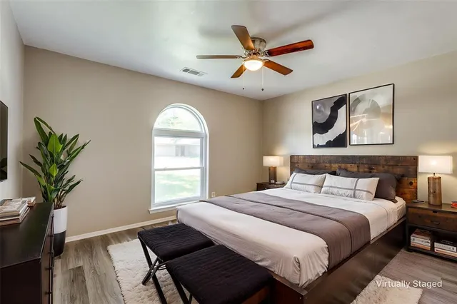 a bedroom with a large bed and a chandelier