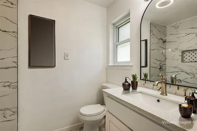 a bathroom with a sink toilet and mirror