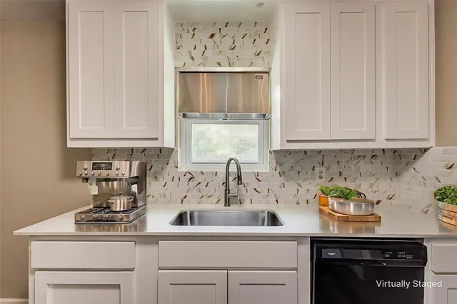 a kitchen with a sink and cabinets