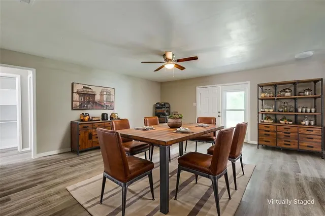 a view of a dining room with furniture and wooden floor
