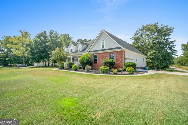 a view of a house with a garden and plants