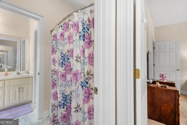 a bedroom with a bed and a lamp