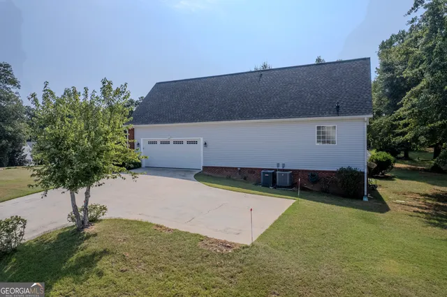 a backyard of a house with plants and outdoor seating