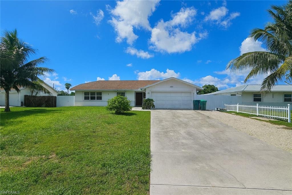 5010 31st Avenue Southwest Naples, FL 34116 - Photo 1 of 33 a front view of house with yard and green space