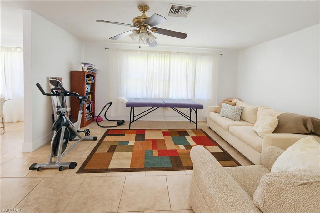 5010 31st Avenue Southwest Naples, FL 34116 - Photo 11 of 33 a room with gym equipment and a large window