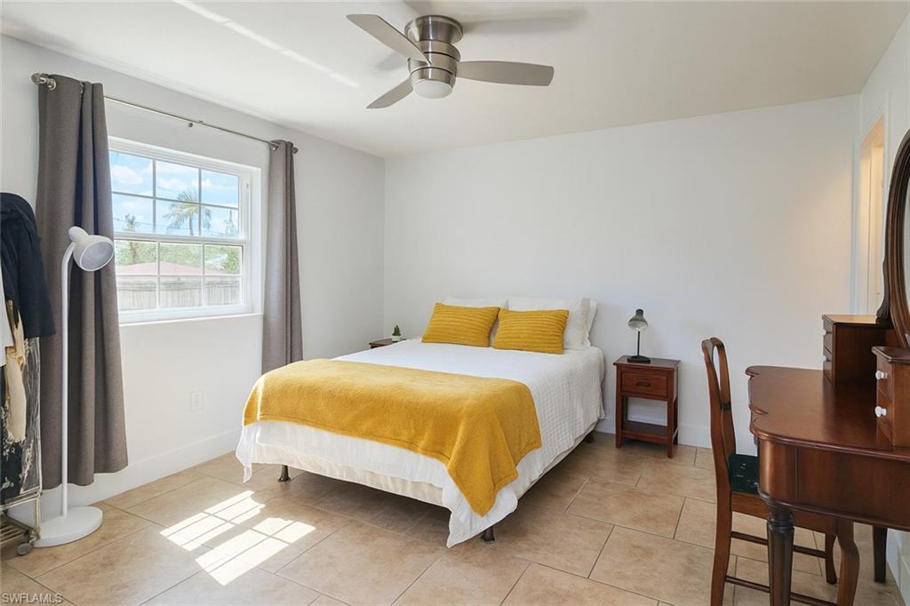 5010 31st Avenue Southwest Naples, FL 34116 - Photo 17 of 33 a bedroom with a bed and a window