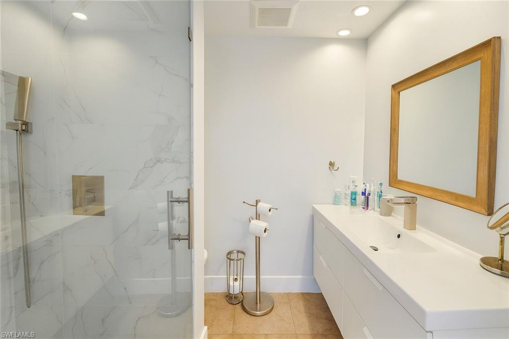 5010 31st Avenue Southwest Naples, FL 34116 - Photo 19 of 33 a bathroom with a tub sink and mirror