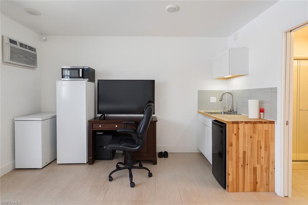5010 31st Avenue Southwest Naples, FL 34116 - Photo 22 of 33 a view of workspace with furniture and natural light