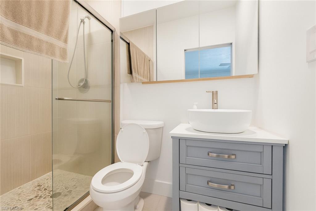 5010 31st Avenue Southwest Naples, FL 34116 - Photo 25 of 33 a bathroom with a toilet a sink and a shower