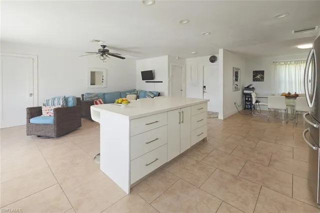 a kitchen with cabinets stainless steel appliances and a counter space