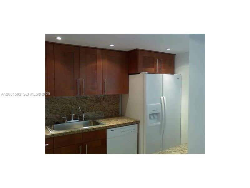 150 Southeast 25th Road, Unit 8L Miami, FL 33129 - Photo 4 of 12 a kitchen with a refrigerator and a sink