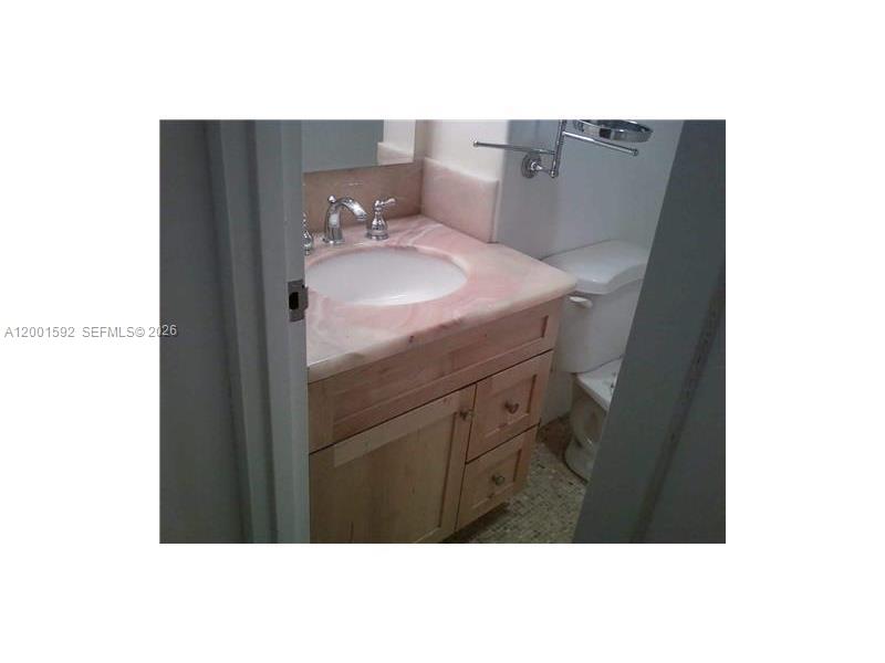 150 Southeast 25th Road, Unit 8L Miami, FL 33129 - Photo 5 of 12 a bathroom with a sink vanity and mirror