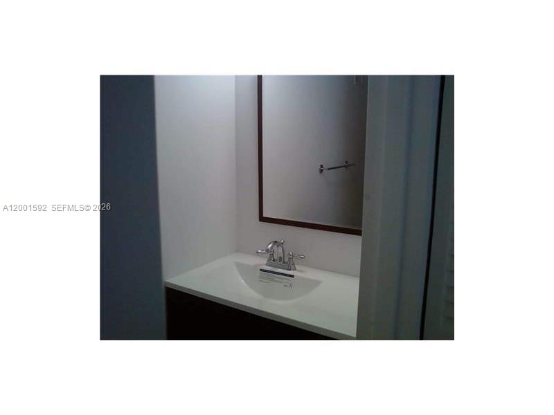 150 Southeast 25th Road, Unit 8L Miami, FL 33129 - Photo 8 of 12 a bathroom with a sink and a mirror
