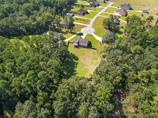 an aerial view of a house with a yard swimming pool outdoor seating and yard