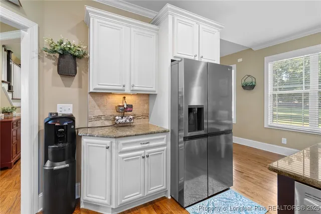 a bathroom with double vanity sinks a vanity a lamp and a mirror