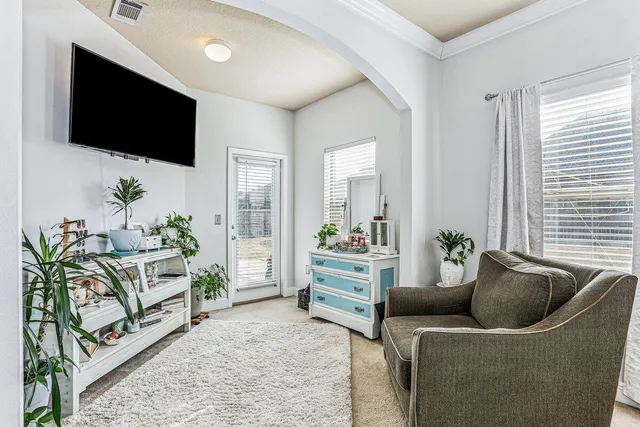 a bedroom with a bed and a large window