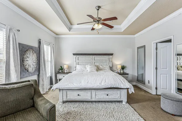 a bedroom with a large bed couch and a window