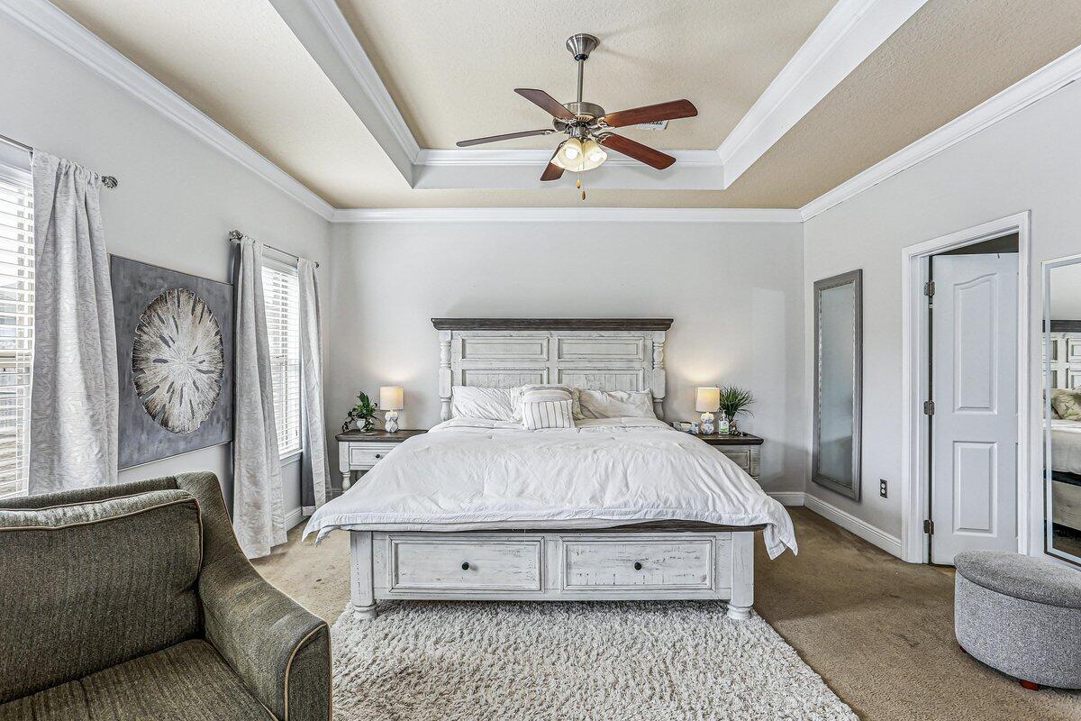 405 Pendo Place Crestview, FL 32536 - Photo 16 of 39 a bedroom with a bed and a chandelier