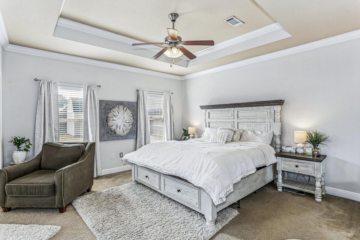 405 Pendo Place Crestview, FL 32536 - Photo 17 of 39 a bedroom with a large bed couch and a window