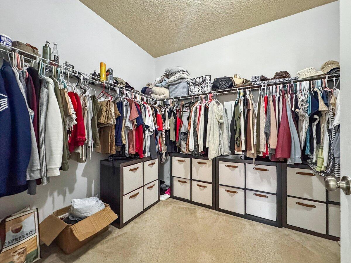 405 Pendo Place Crestview, FL 32536 - Photo 18 of 39 a view of walk in closet with clothes