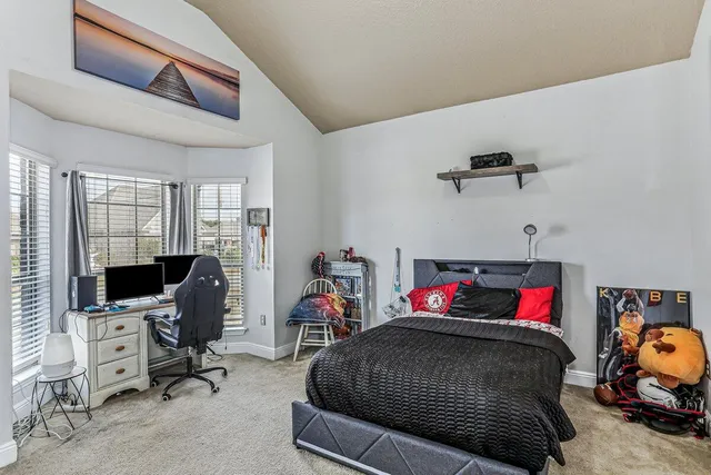 a bedroom with furniture and a flat screen tv