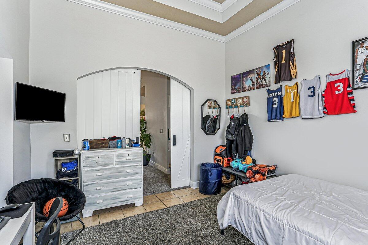 405 Pendo Place Crestview, FL 32536 - Photo 22 of 39 a bedroom with furniture and a flat screen tv