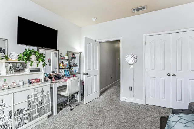 a bedroom with furniture a ceiling fan and a window