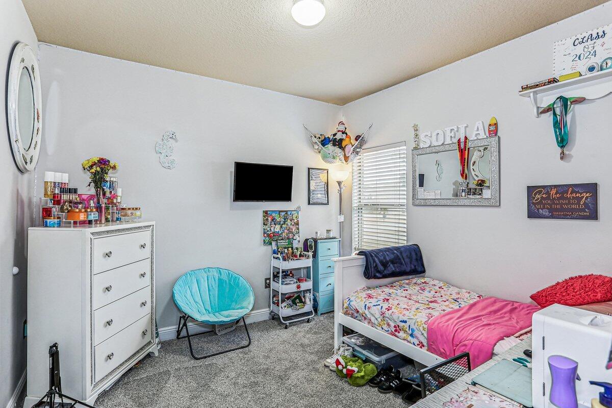 405 Pendo Place Crestview, FL 32536 - Photo 26 of 39 a bedroom with a bed and a flat screen tv